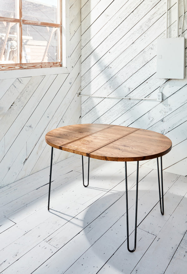 small solid wood table with metal base